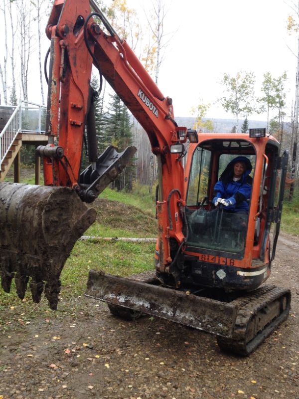 Orange Backhoe performing septic field installation